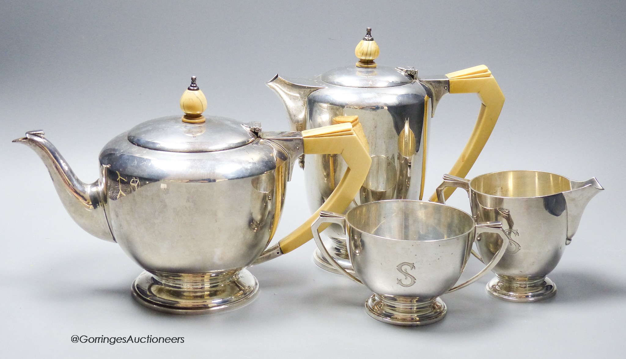 A 1930's Art Deco silver four piece tea set, with ivory handles, by Edward Barnard & Sons, London, 1937, gross 50oz, all with engraved initial.